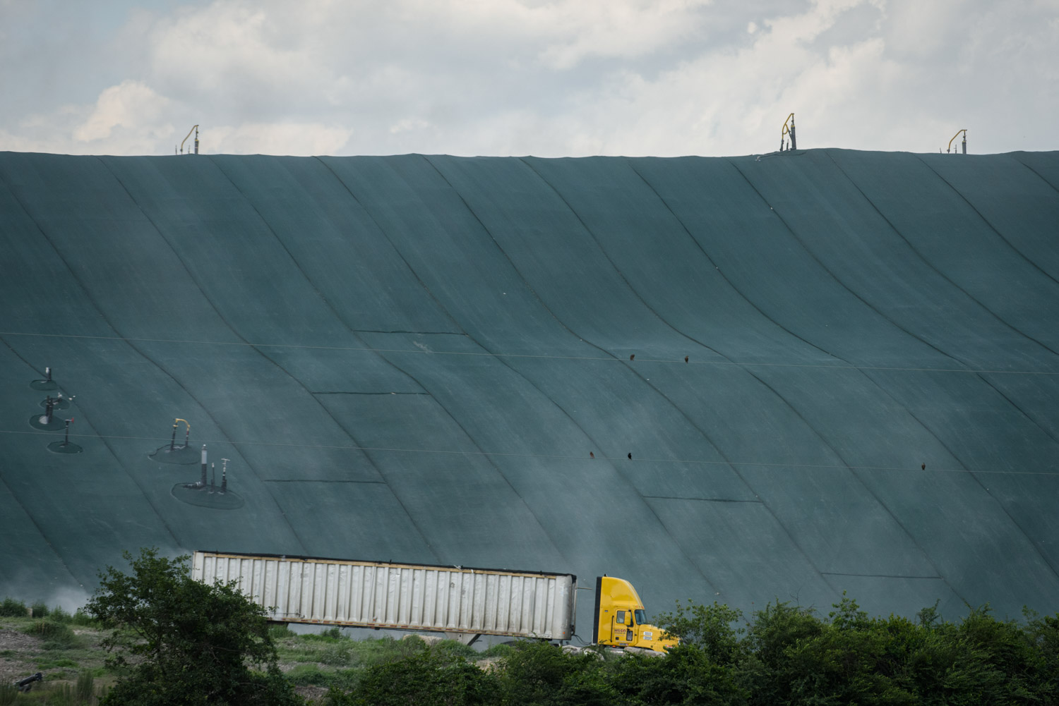 A tractor trailer makes it way down the mound after dumping waste at the Sampson County landfill near Roseboro, N.C.