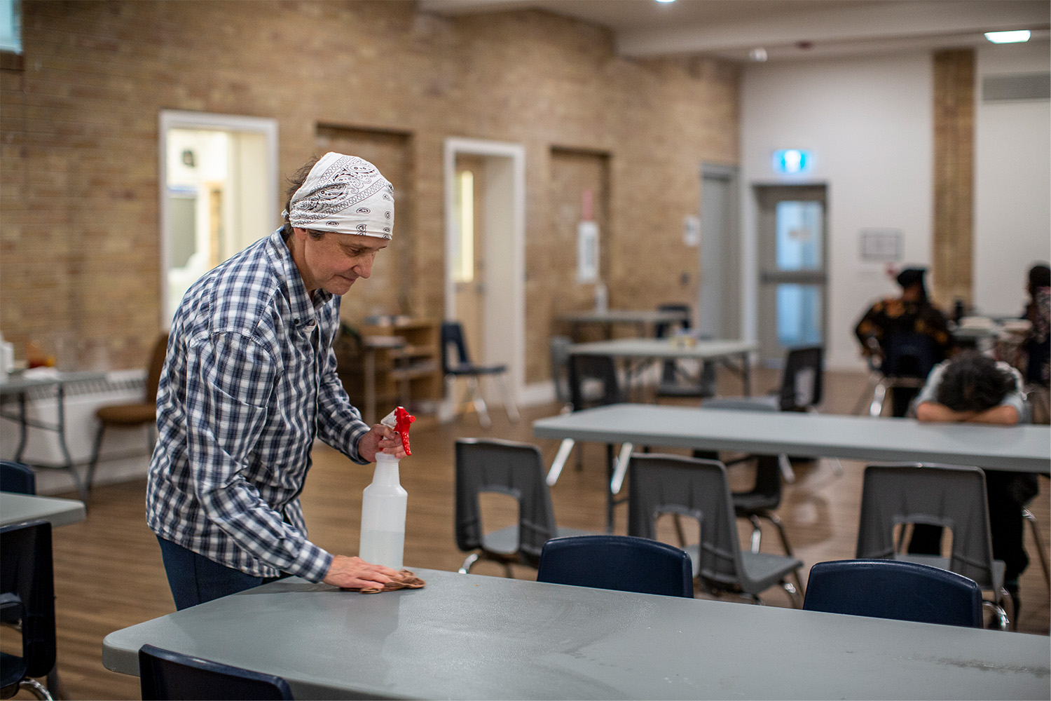 A volunteer cleans the tables at Cummer Avenue United Church in July, 2024. 