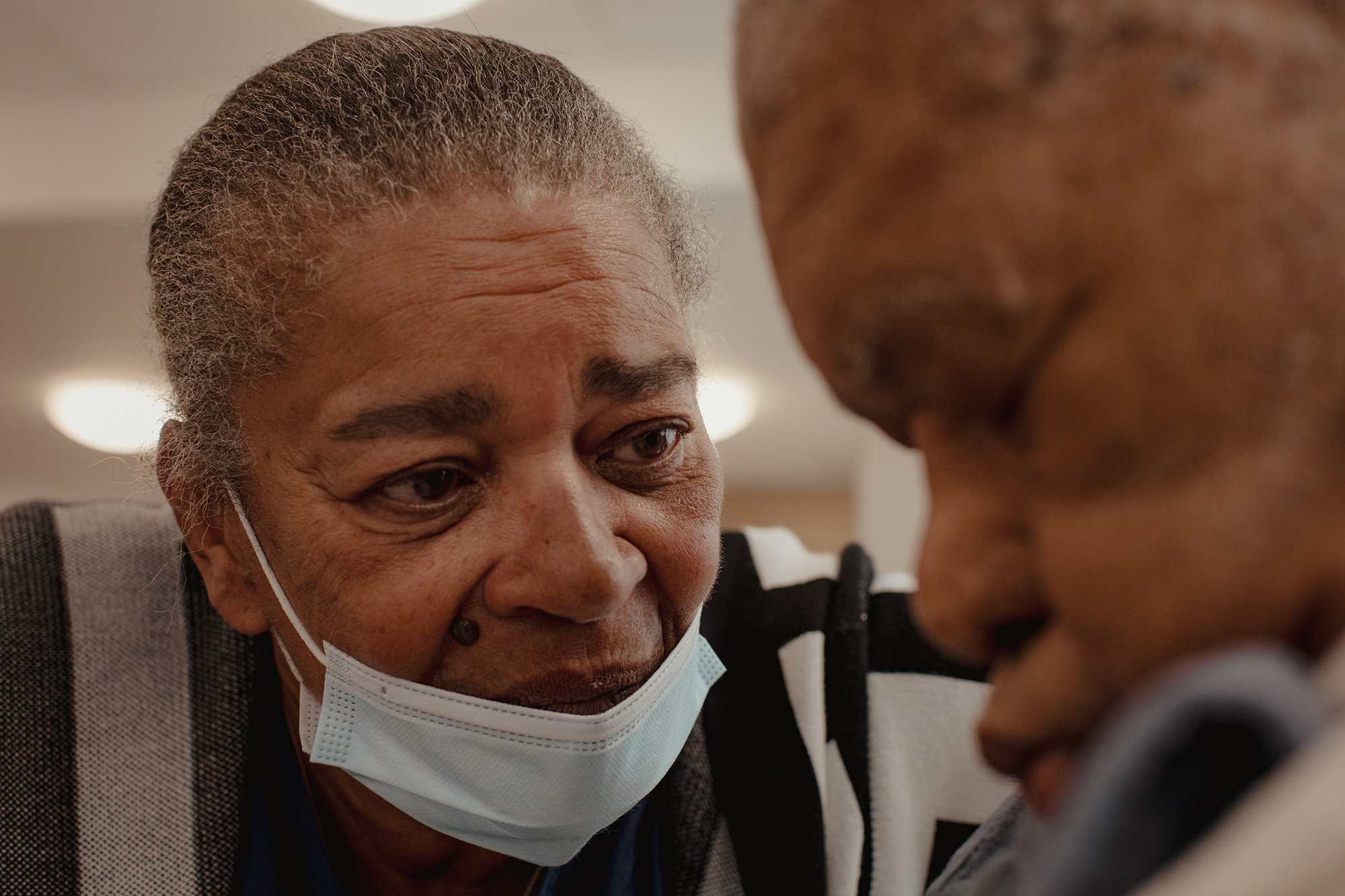 Sandra Tierney sits with her father, Claude Forrester, during dinner at Wellbrook Place. In an attempt to help him eat, Sandra sometimes tries to persuade him. “Listen, remember when you used to feed me?” she asks. “I had to eat it no matter what.”