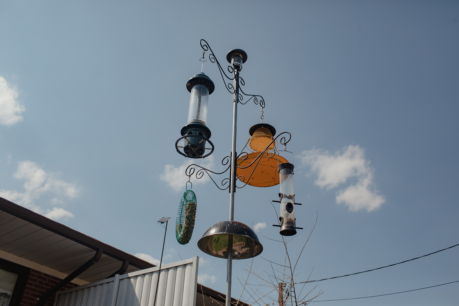 Left, Maria’s stove in the house she lived in since immigration to Canada from Italy. “She loved cooking,” said her son, Alex. “Everything was homemade here. Right, birdfeeders sit in the front yard of the house.