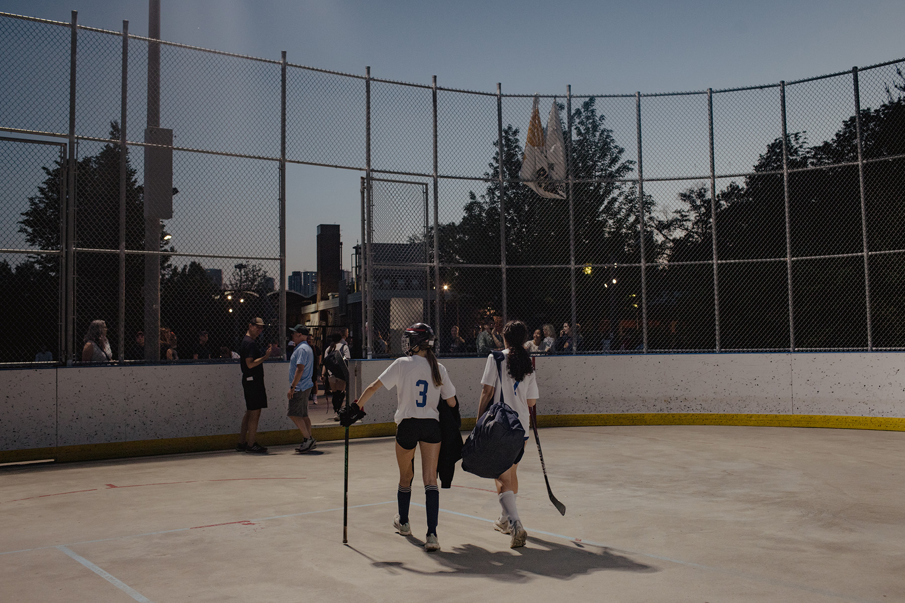 Athletes leave the arena after their ball hockey game is over.