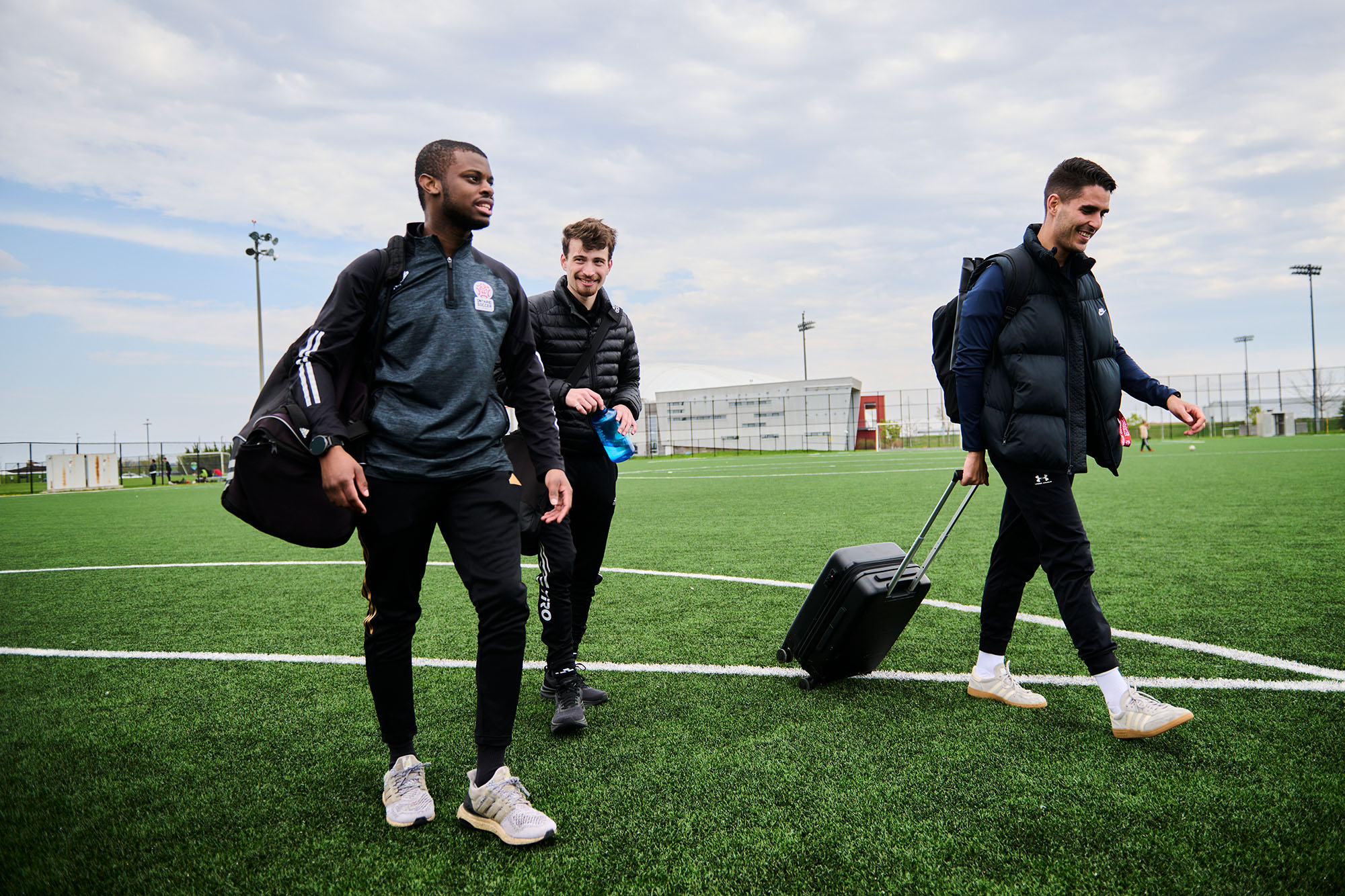 Referees Jared Marshall, left, Ben Kivenko and Josue Tomas leave a game at Downsview Park in May.