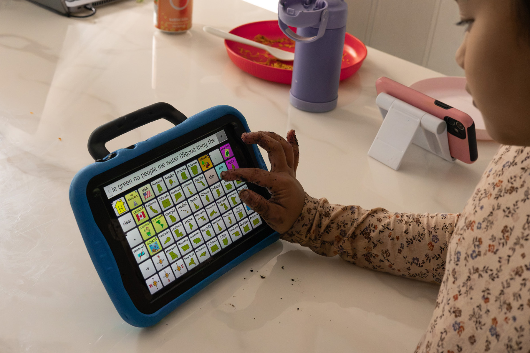 Left, Katalina Carillo's weekly schedule provides her with a visual representation of what her upcoming week will look like. Right, Katalina uses her communication device to ask for help washing the soil off of her hands.