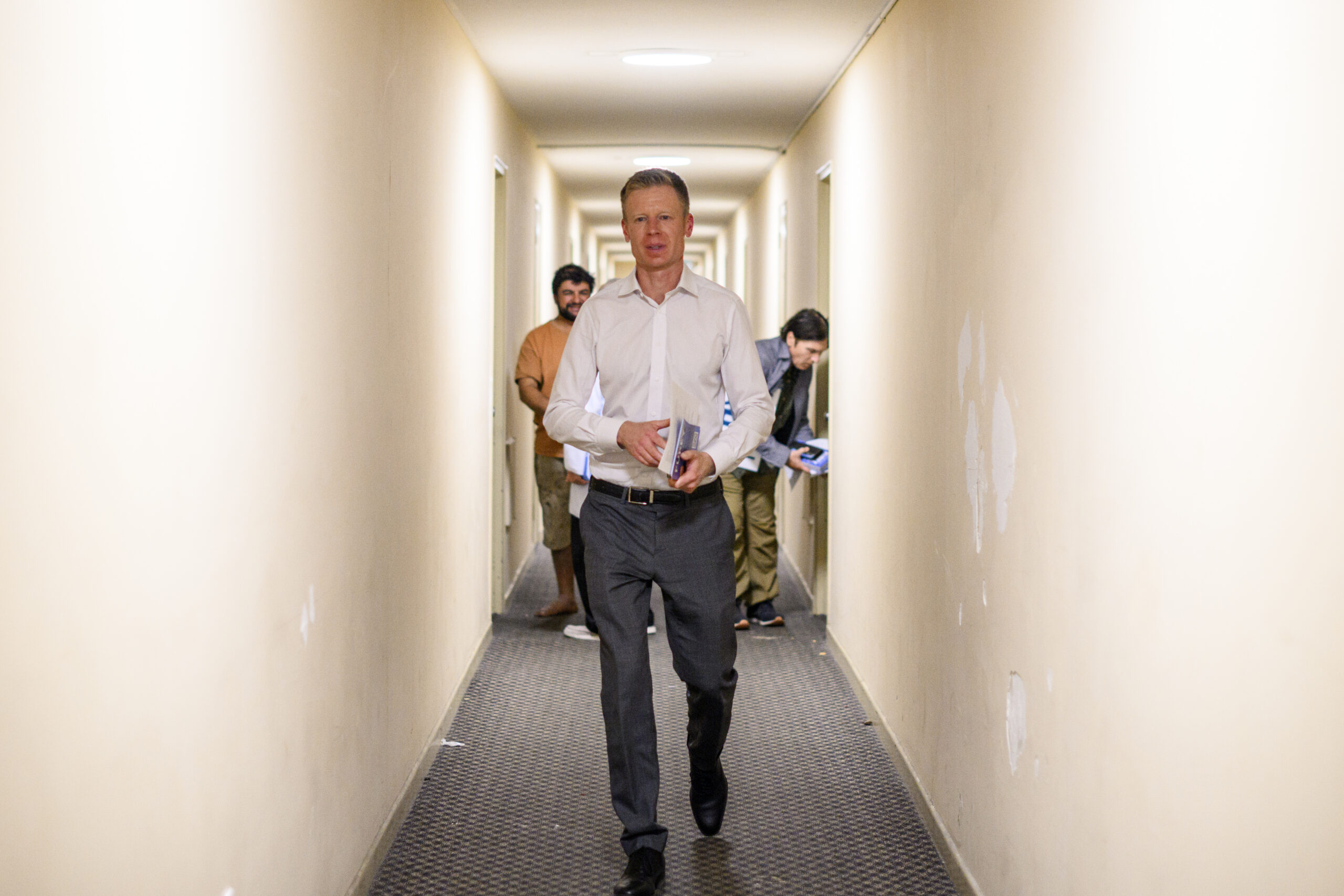 Left, Anthony Furey speaks with volunteers ahead of canvassing a building in Thorncliffe Park during the municipal by-election in 2024. Right, Furey canvasses a building in Thorncliffe Park in 2024. Photos by Chris Katsarov Luna / The Local