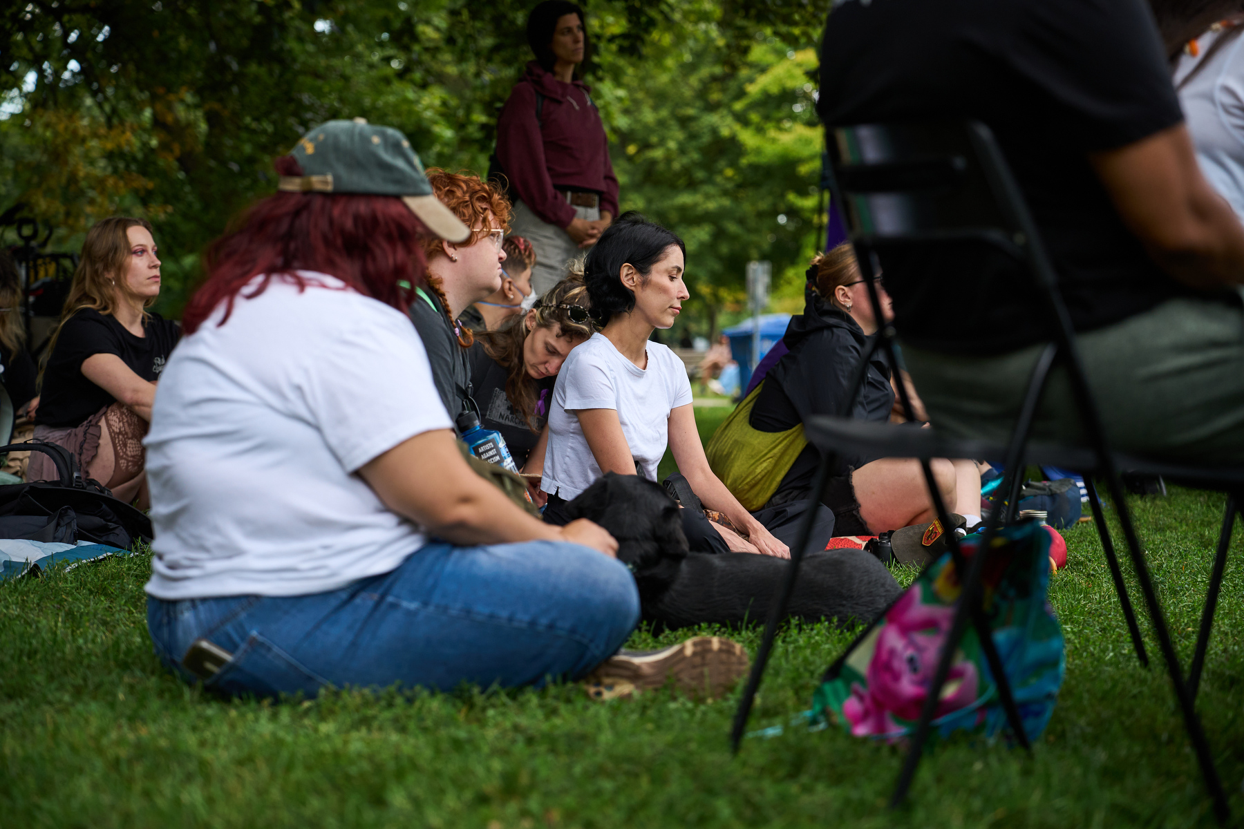 McNally sits with attendees at an overdose awareness event at Trinity Bellwoods Park.