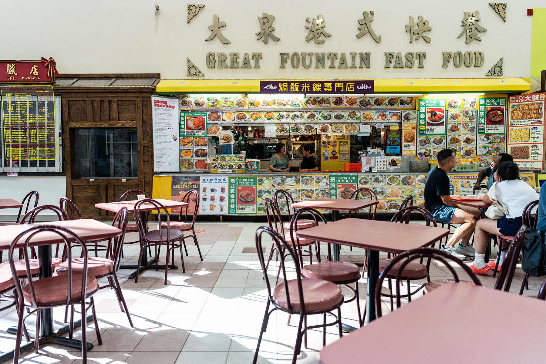 Scarborough North is the smallest ward in the city, and also one of the most diverse. Left, Ussman Jemal from Fahmee Bakery packs a box of Jamaican Patties for customers at their new location in Malvern Town Centre. Right, Anna Peng chats with her mother behind the counter of family-run Great Fountain Fast Food, which serves Hong Kong-style cuisine.
