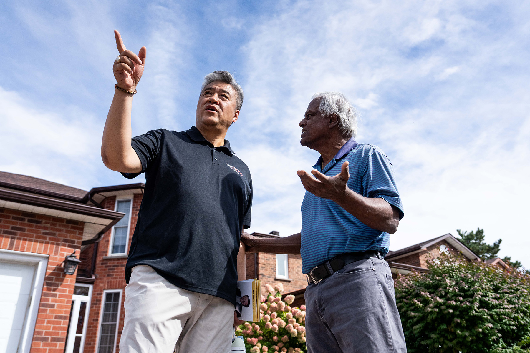 Left, Dong canvasses the ward with volunteers in September. Right, Dong speaks with retired provincial and municipal politician Bas Balkissoon while canvassing.