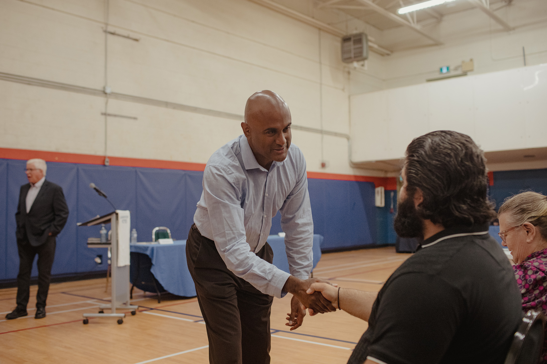 Parthi Kandavel greets attendees at a candidates forum in September.