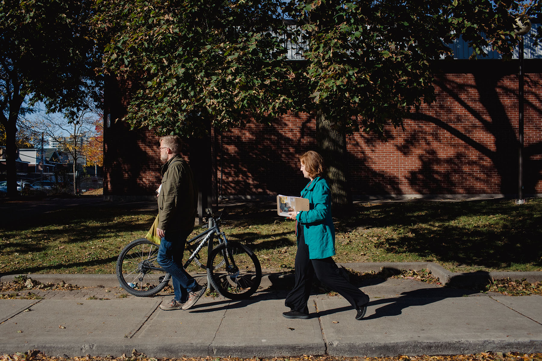 Left, Ehrhardt is stopped by a constituent at Alexander the Great Parkette to discuss pay equity. Right, Ehrhardt canvasses Toronto-Danforth. Photos by Chloë Ellingson / The Local