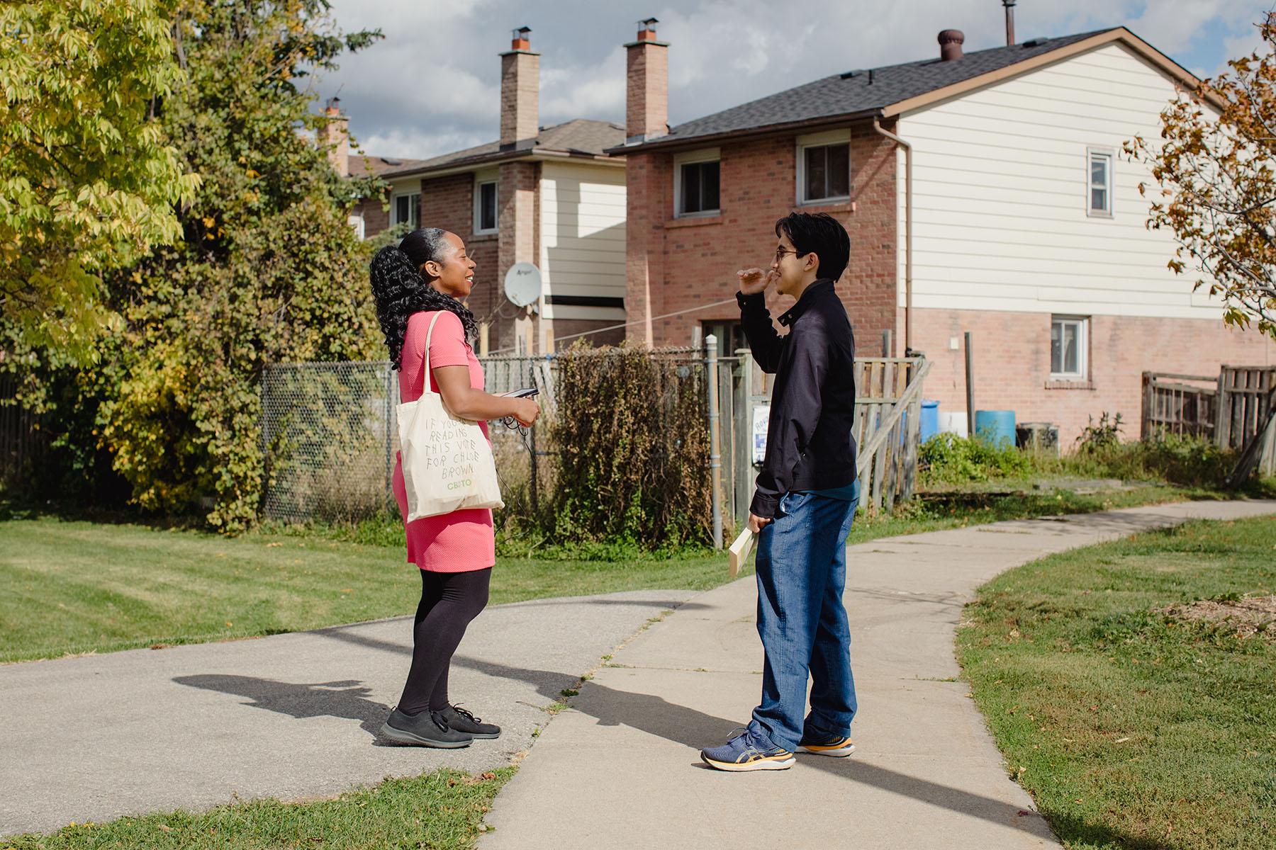 Brown speaks with a student who stopped her to discuss her platform on his way to the bus stop.