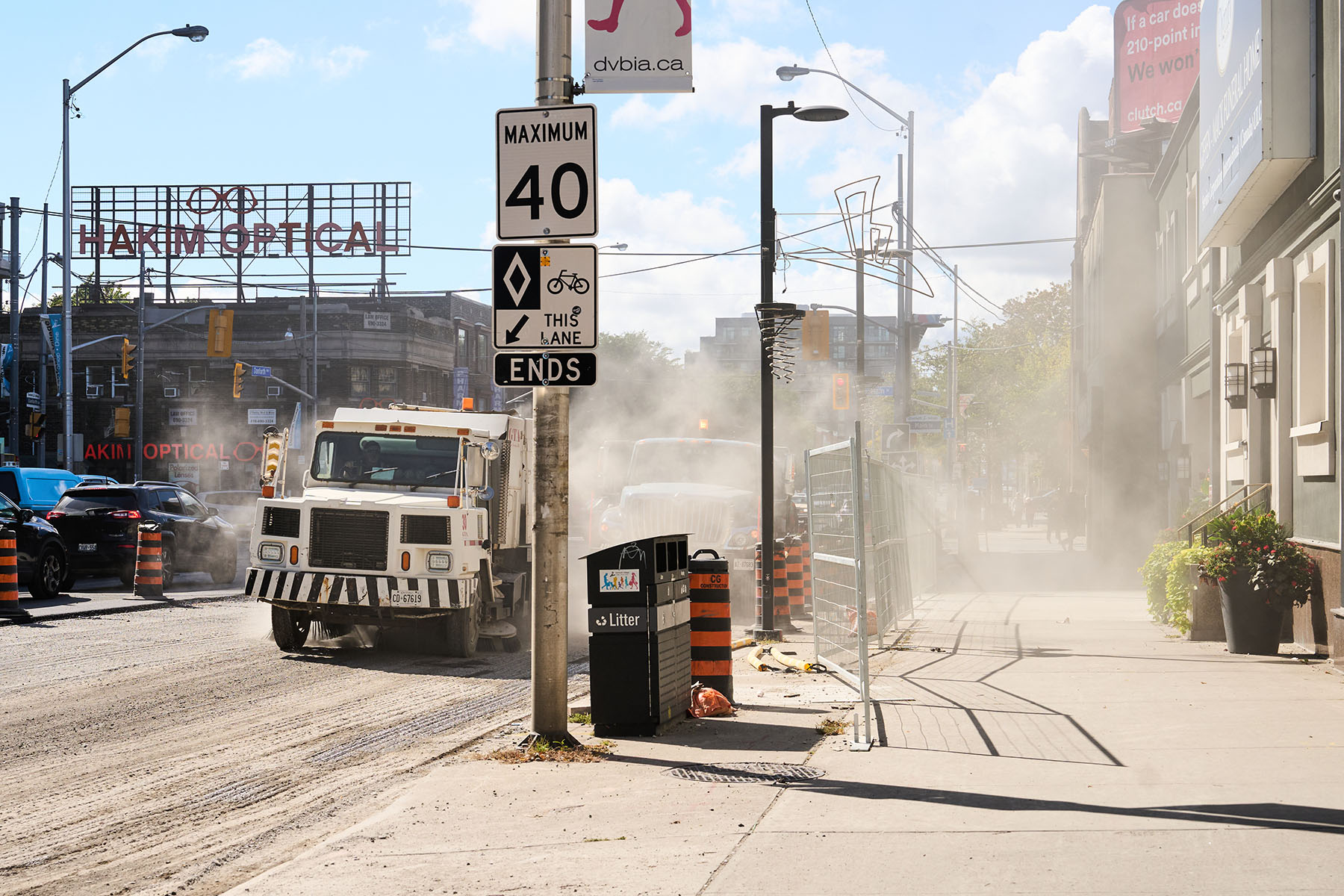 Trucks kick up dust as they drive on Danforth Avenue east of Main Street.